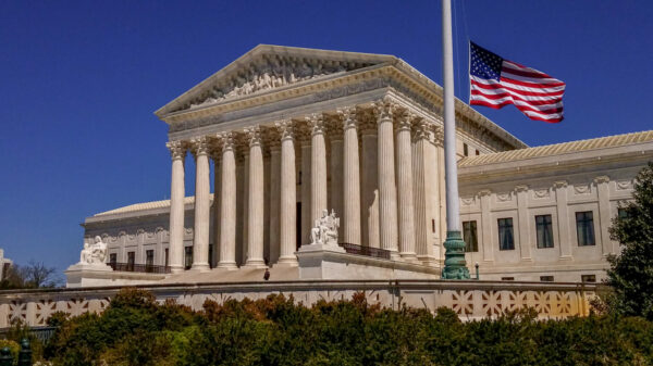 Supreme Court of the United States and American Flag in Washington, DC alternate text for this image