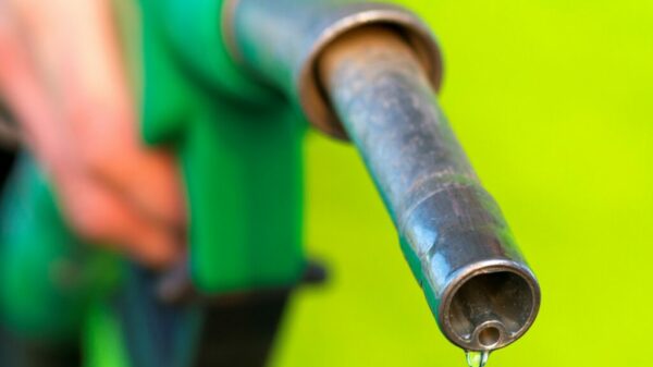 Male hand holding green pump alternate text for this image