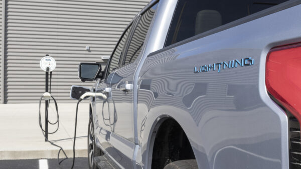 Ford F-150 Lightning display. Ford offers the F150 Lightning all-electric truck in Pro, XLT, Lariat, and Platinum models. alternate text for this image