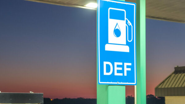 Diesel exhaust fluid or DEF sign posted in a truck stop, next to fuel pump alternate text for this image