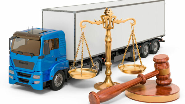 Truck with wooden gavel and scales of justice. 3D rendering isolated on white background alternate text for this image