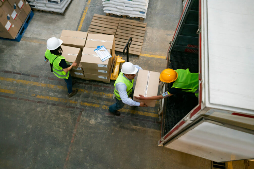Vue en hauteur de personnes qui déchargent un camion à la main