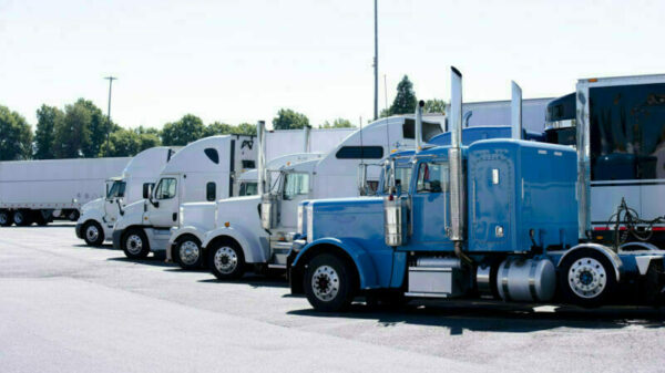 Truck stop with row of big rigs semi trucks alternate text for this image
