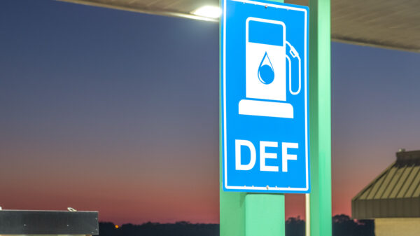Diesel exhaust fluid or DEF sign posted in a truck stop, next to fuel pump alternate text for this image