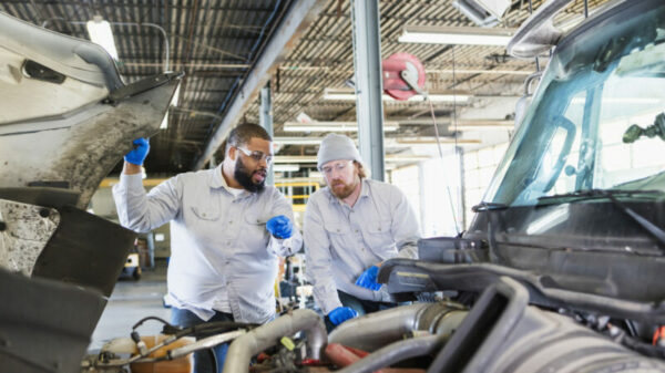 Team of mechanics repairing semi-truck alternate text for this image