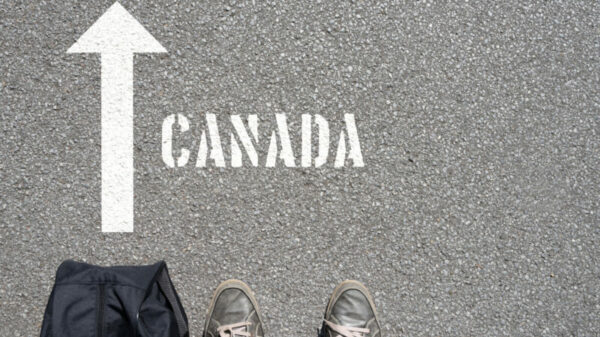 A man with a travel bag on his way to Canada alternate text for this image