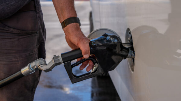 Hand Refilling the Car with Fuel at the Refuel Station alternate text for this image